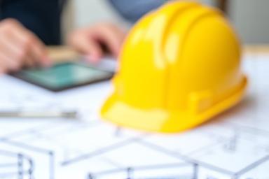 Architectural plans and construction helmet.